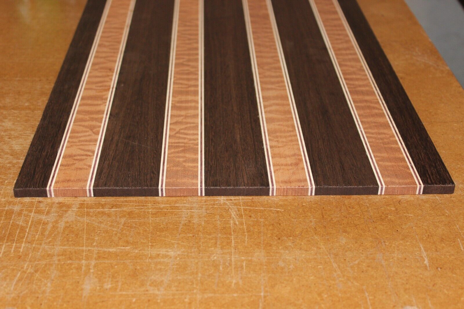 Quilted sapele, wenge, maple and purple-heart laminated electric guitar top.