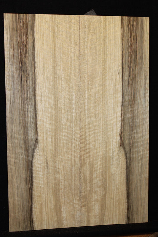 Curly black limba / korina figured book matched guitar top.