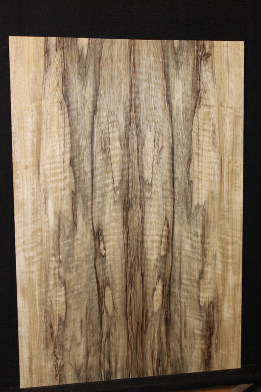 Curly black limba / korina figured book matched guitar top.