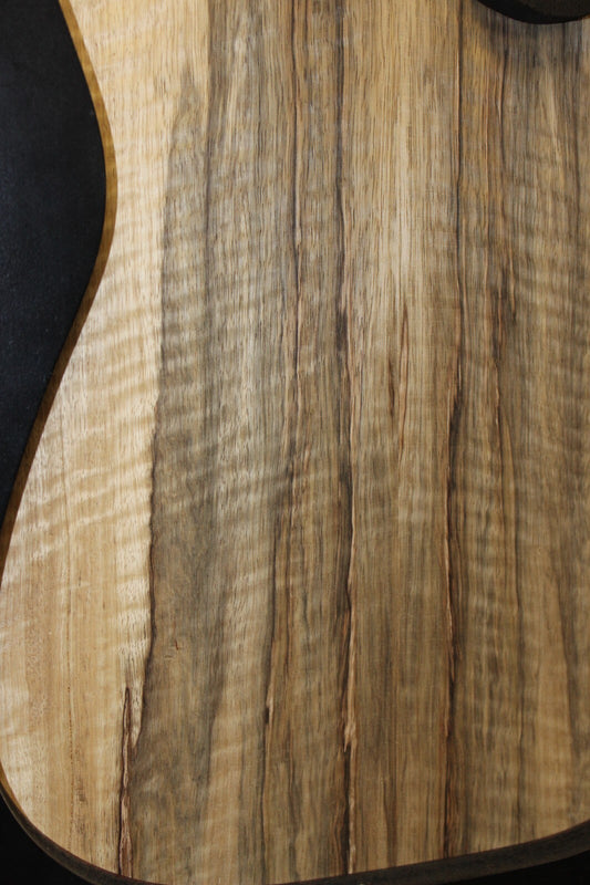 Curly black limba / korina figured book matched guitar top.